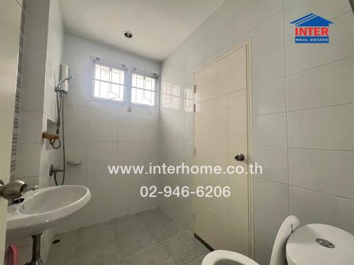 Clean and bright bathroom with white tiles
