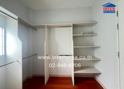 Spacious walk-in closet with built-in shelving and hanging rods
