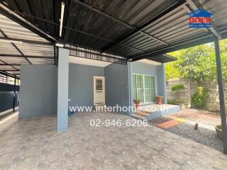 Covered outdoor area with tiled flooring and potted plants