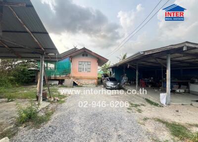 Exterior view of property with covered parking area and visible house entrance