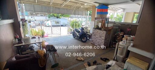 Overview of outdoor space with motorcycle and various items