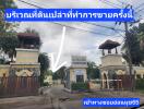 Entrance to Golden Nakara Village with visible security gate and guard towers