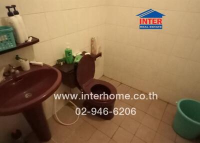 Bathroom with sink, toilet, and cleaning supplies