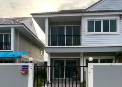 Front view of a two-story house with a fenced yard