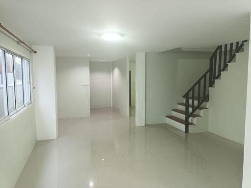 Spacious living room with staircase