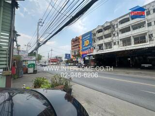 Street view showing nearby buildings and road