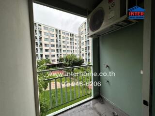 Balcony with view of adjacent buildings and greenery