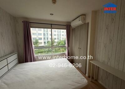 Spacious bedroom with large window and air conditioning