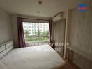 Spacious bedroom with large window and air conditioning