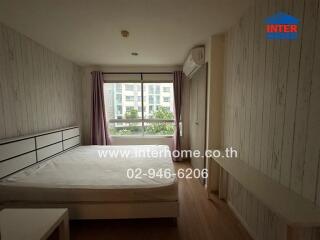 Spacious bedroom with large window and air conditioning