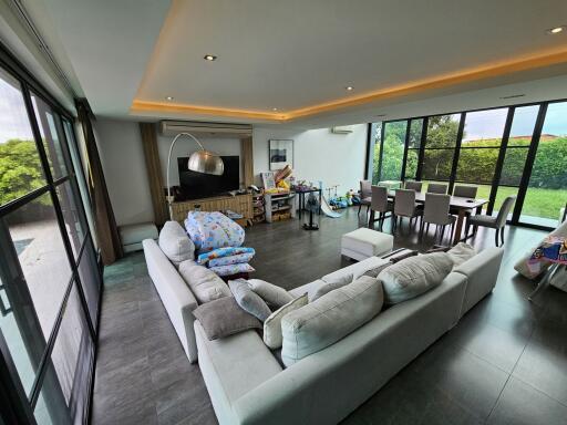 Spacious living area with large windows and comfortable seating