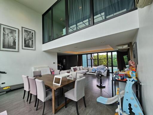 Modern living room with dining area and high ceilings