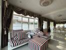 Living room with striped furniture and large windows