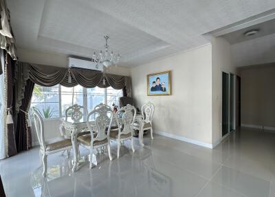 Formal dining room with elegant furniture and large windows