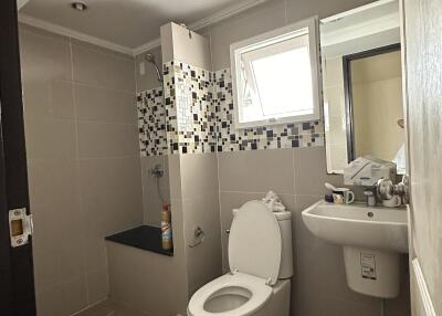 Modern bathroom with shower, toilet, and sink