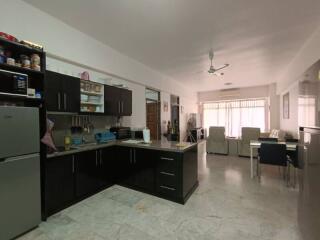 Modern open-plan kitchen leading to a spacious living and dining area