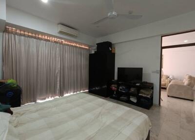 bedroom with bed, mirror, television, and air conditioner