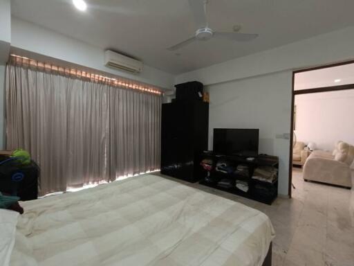 bedroom with bed, mirror, television, and air conditioner