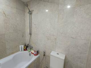 Bathroom with bathtub, showerhead, and toilet