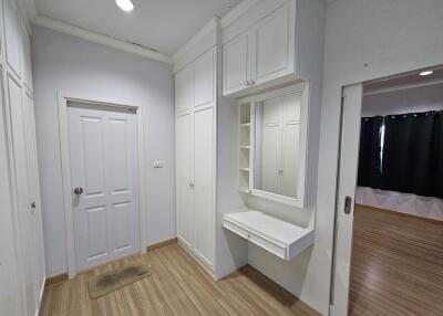 bedroom with built-in closets and dressing area