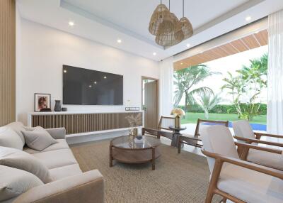 Spacious living room with large wall-mounted TV and outdoor view