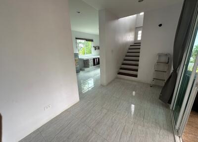 Spacious house interior with stairs and tiled floors
