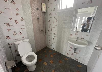 Bathroom with toilet, shower, and sink