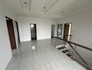 Spacious and modern upstairs hallway with tiled flooring and access to multiple rooms