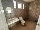 Modern bathroom with tiled walls and a large mirror.