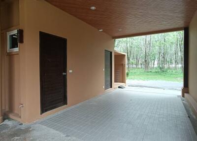Spacious garage with wooden ceiling and tiled floor
