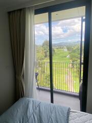 Bedroom with balcony and scenic view