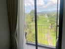 Bedroom with balcony and scenic view