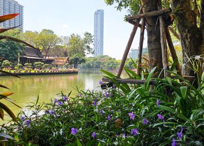 Scenic view of a waterfront area with greenery and tall buildings