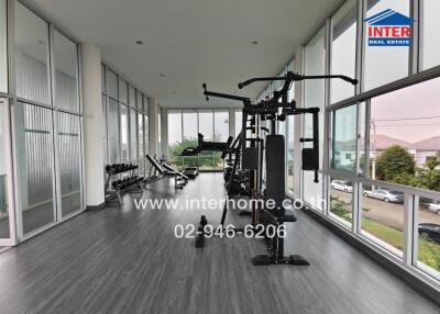 Gym with exercise equipment and large windows
