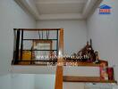 Interior stairway with railing and small personal items on shelves