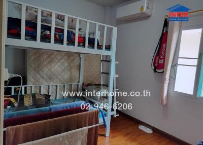 Bedroom with bunk bed, air conditioning, window and wooden floor