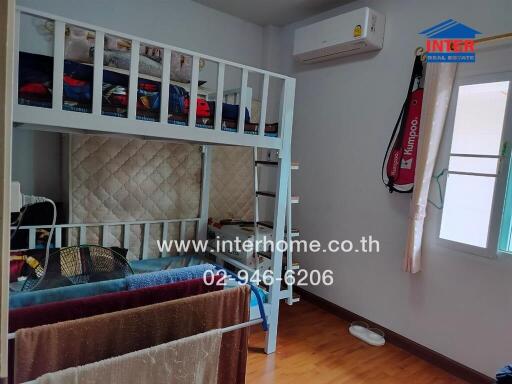 Bedroom with bunk bed, air conditioning, window and wooden floor