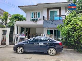 Two-story house with a car parked in front