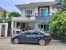 Two-story house with a car parked in front