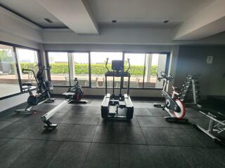 Well-equipped home gym with exercise bikes and weight lifting area