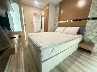 Modern bedroom with wooden furniture and ensuite bathroom