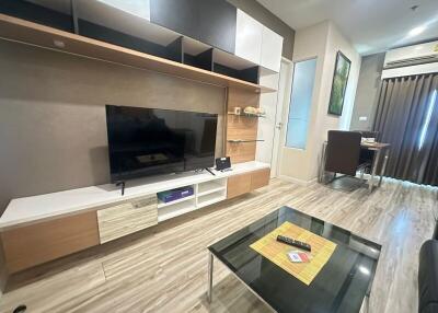 Modern living room with entertainment center and glass coffee table