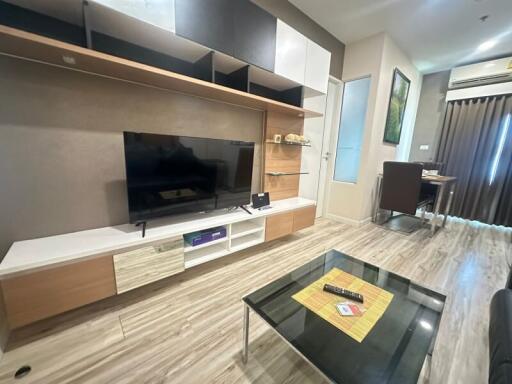 Modern living room with entertainment center and glass coffee table