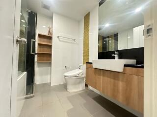 Modern bathroom with shower, toilet, and vanity sink