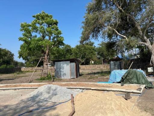 Construction site with building materials and temporary structures