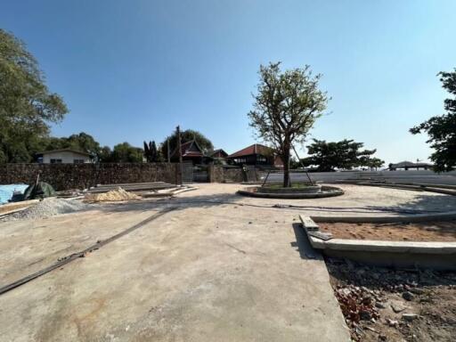 Construction site with surrounding houses and trees