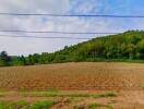 Empty plot of land with a view of a hill and sky