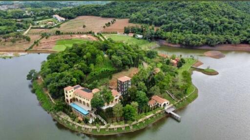 Aerial view of a property on an island surrounded by a lake