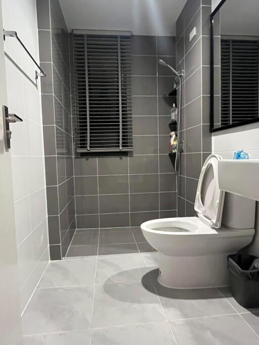 Modern bathroom with gray tiles and a large walk-in shower