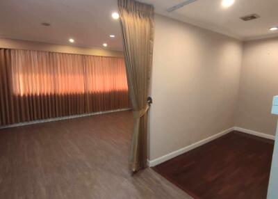 empty room with curtain, wooden floor and recessed lighting